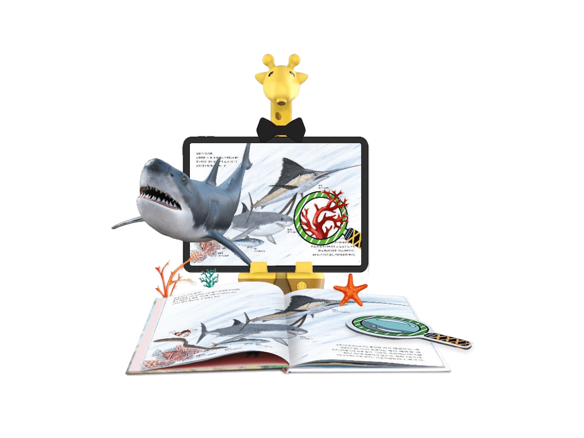 An ARpedia AR book with a 3D shark leaping off the page above the Spotty tablet holder